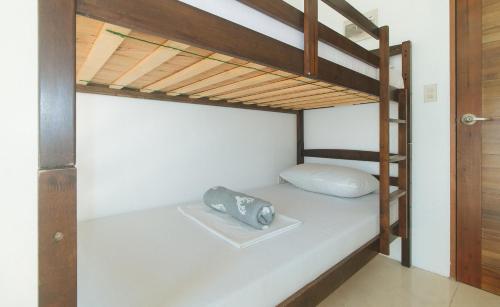 a room with a bunk bed with a pillow on a bed sidx sidx at Stay Manila Hotel by RedDoorz in Manila