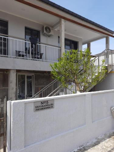 a house with a white fence and a sign on it at Weekender - guest house in K'obulet'i
