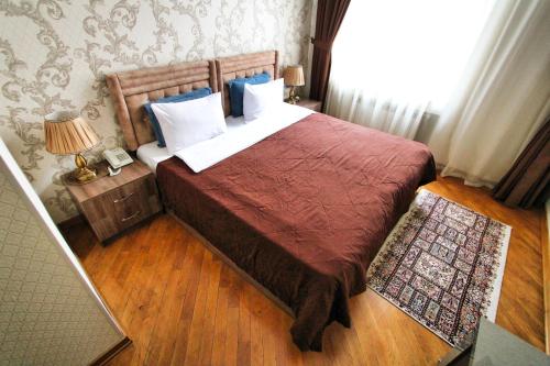 a bedroom with a large bed and a window at Prime Boutique Hotel in Baku