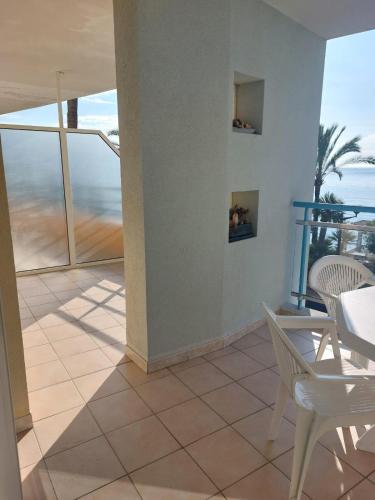 un balcon avec une table et des chaises et l'océan dans l'établissement Atelier Sonia, à Roquebrune-Cap-Martin