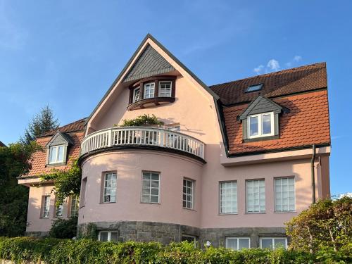 a large house with a balcony on top of it at Rosa Villa Selb in Selb