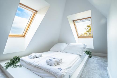 a bedroom with a bed with towels on it at RJ Apartments Chopina in Sopot