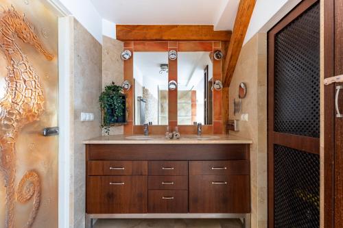 a bathroom with a sink and a mirror at RJ Apartments Chopina in Sopot