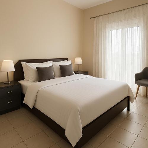 a bedroom with a large white bed and a window at Sky Apartment in Ofrínion