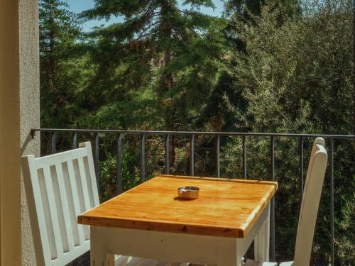 a wooden table and two chairs on a balcony at Sea Garden Kaş Hotel in Kas