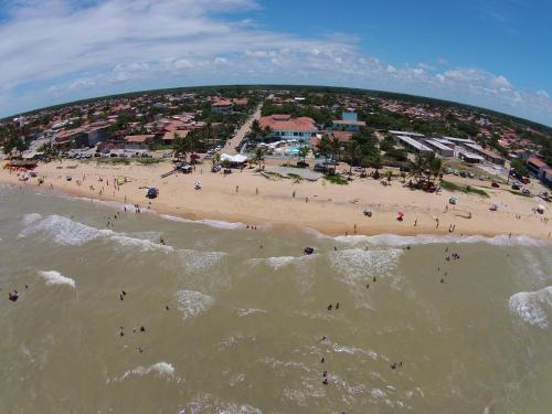 an aerial view of a beach with people in the water at Hotel Paraiso Tropical in Alcobaça