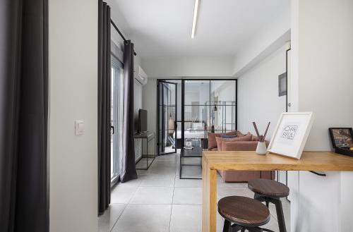 a room with white walls and a table and chairs at The Omnia Collection Pagrati in Athens