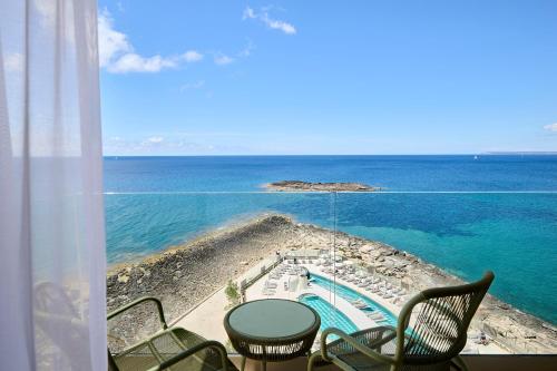 a view of the ocean from a room with a table and chairs at Iberostar Selection Es Trenc -New Opening- in Colonia Sant Jordi