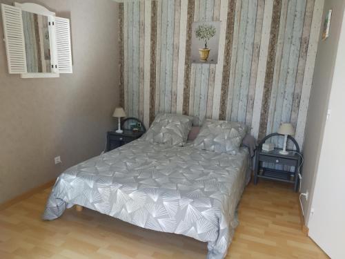 une chambre avec un lit et deux tables de nuit dans l'établissement L'éolyre, à La Motte-dʼAigues