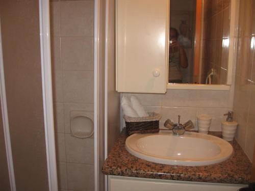 a bathroom with a sink and a mirror at Zena Holiday Villa in Pissouri