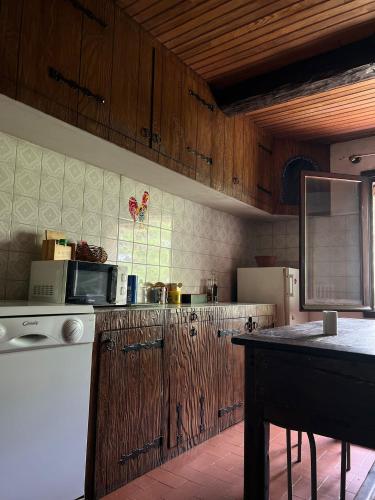 a kitchen with wooden cabinets and a counter top at Belle chambre en bois chez Antoine in Montpellier