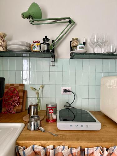 a kitchen counter with a sink and a cutting board at Fritto Misto Comune Stays in Fabriano