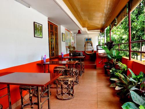 a restaurant with tables and chairs and plants at Sajhome Fortkochi, Kochi, Kerala, inda in Cochin