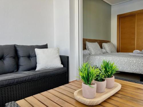 a living room with a couch and a bed at Charming apartment with a pool and golf view in Sucina