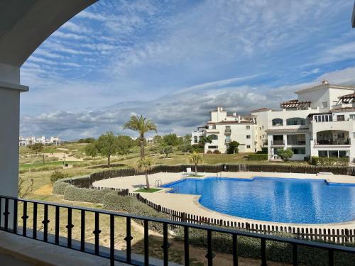 a view of the pool from the balcony of a apartment at Charming apartment with a pool and golf view in Sucina