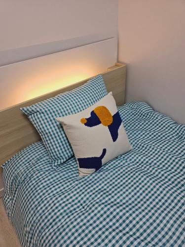 a bed with a pillow with a penguin on it at Premium Incheon Apart in Incheon