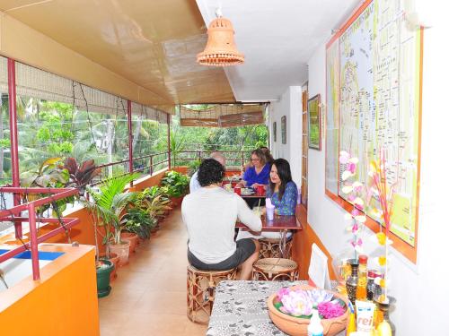 a group of people sitting at a table in a restaurant at Sajhome Fortkochi, Kochi, Kerala, inda in Cochin