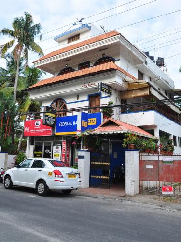 a white car parked in front of a building at Sajhome Fortkochi, Kochi, Kerala, inda in Cochin