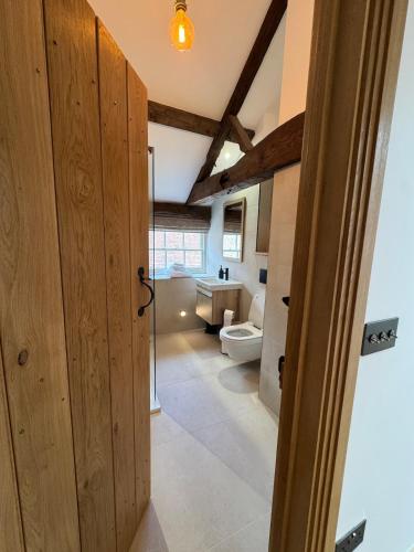 a bathroom with a toilet and a sink at The Menagerie in Towcester