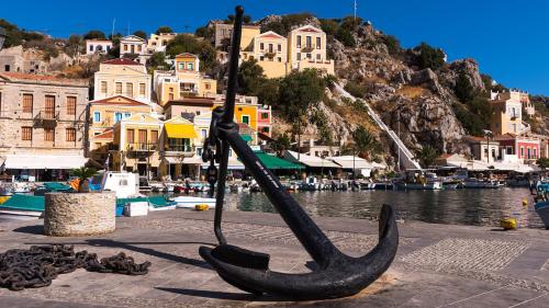 a statue of a boat on the side of a body of water at Lemonitissa Villa in Symi