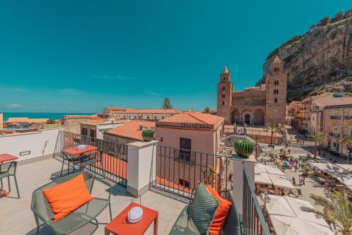 a balcony with a view of a city and the ocean at Palazzo Villelmi in Cefalù