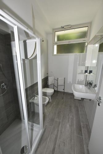 a bathroom with a toilet and a sink and a shower at Appartamenti Fossato in Tremosine Sul Garda