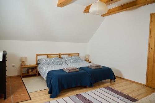 a bedroom with a bed with two towels on it at Kőris Tanya in Hódmezővásárhely