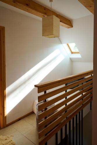 a skylight in the ceiling of a room with a staircase at Kőris Tanya in Hódmezővásárhely