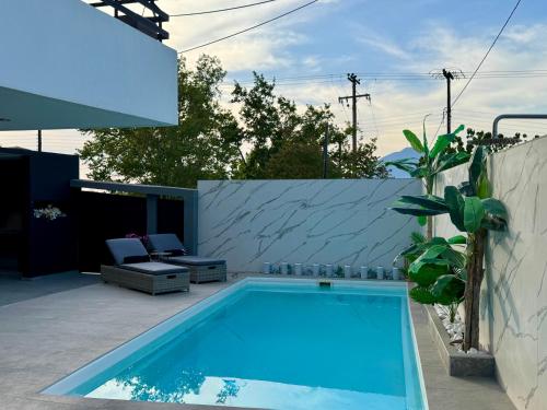 a swimming pool in the backyard of a house at Elite Water House in Patra