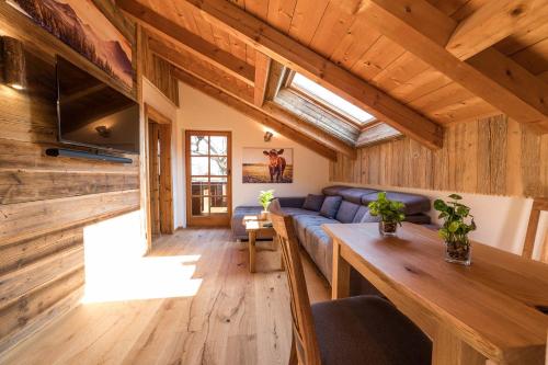 a living room with a blue couch and a table at Ferienwohnung Bergliebe in Schleching