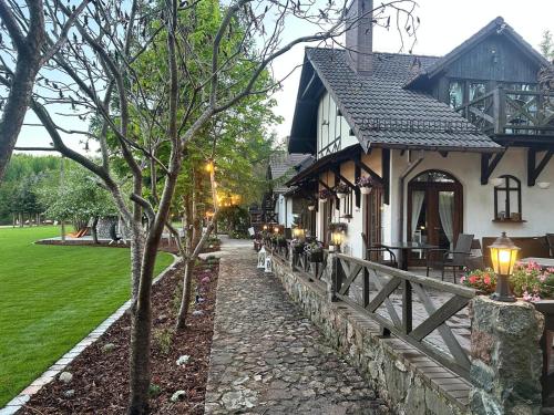 a house with a stone path in front of it at Rybakówka Marina Restaurant in Sokole-Kuźnica