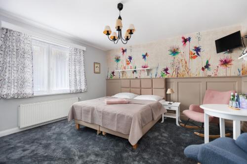 a bedroom with a bed and a table at Rybakówka Marina Restaurant in Sokole-Kuźnica