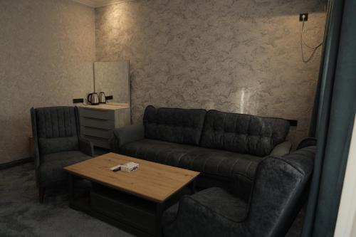 a living room with a couch and a coffee table at Ani Resort in Artavaz
