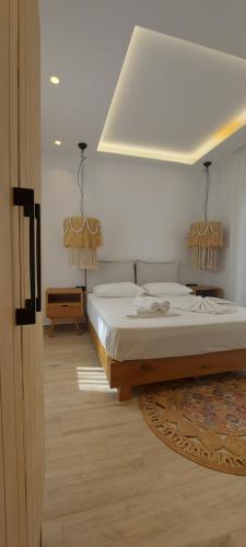 a bedroom with a large bed and a room with at Apartments Anna Maria in Agia Anna Naxos