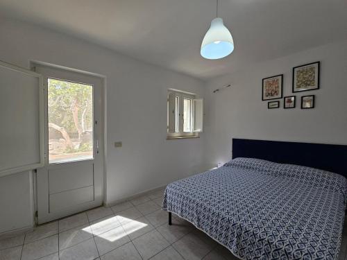 a white bedroom with a bed and a window at Casa Francesca Ponza in Ponza