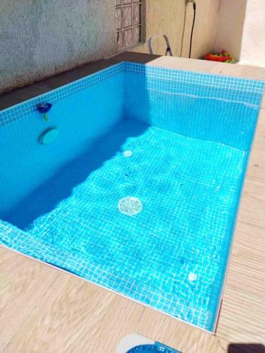 a swimming pool with a turquoise tiled floor at Luxury mini villas AA in Kríni