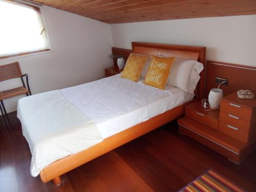 a bedroom with a bed with white sheets and orange pillows at Mundaka Vista Mar L-BI-52 in Mundaka