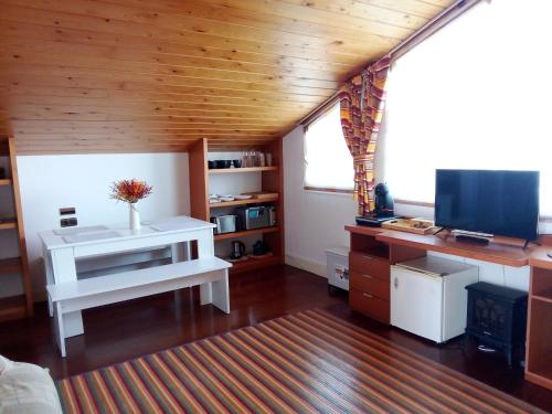 a living room with a desk and a television at Mundaka Vista Mar L-BI-52 in Mundaka