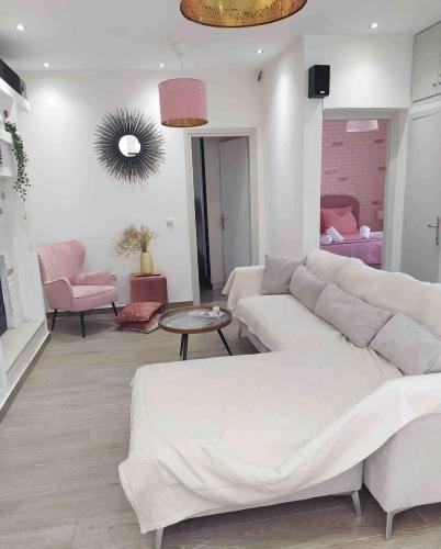 a living room with a white couch and a table at Luxury mini villas AA in Kríni