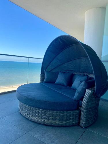 a bed in a room with a cover over it at Wave Resort&Spa - Top Penthouse in Międzyzdroje