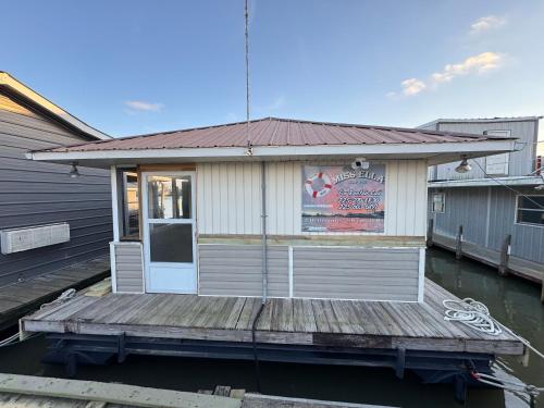 a restaurant on a dock on the water at The Miss Ella Houseboat 