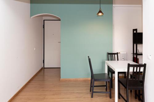 a dining room with a table and chairs and a door at The Glyfada Hideaway in Athens