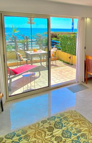 a bedroom with a view of the ocean at Beach and Sea View in Roquebrune-Cap-Martin