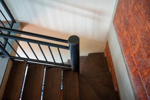 a spiral staircase in a building with a metal railing at Villa Katipadu Coorg in Srimangala