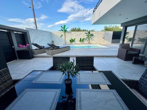 a patio with a table and chairs and a pool at Elite Water House in Patra