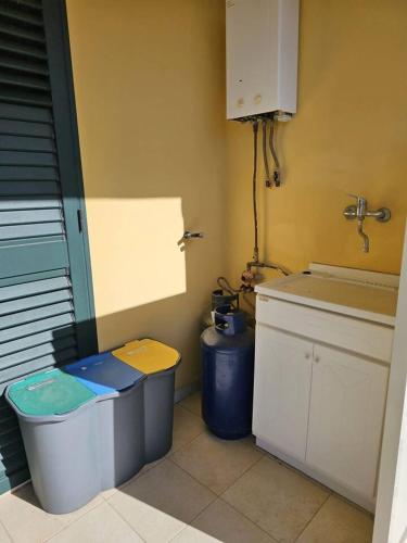 a bathroom with a sink and a toilet and a counter at A pochi passi dal mare Melito PS in Melito di Porto Salvo