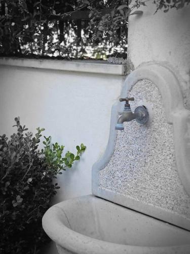 a bathroom sink with a faucet and a plant at A pochi passi dal mare Melito PS in Melito di Porto Salvo