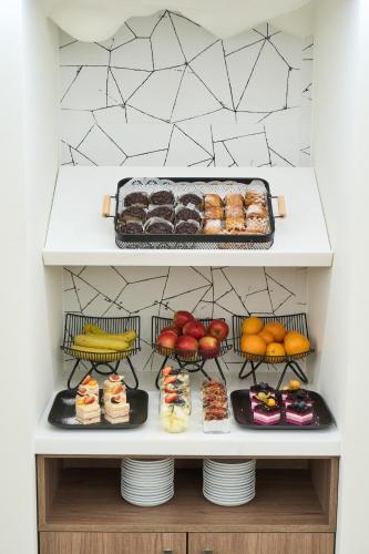 a shelf with different types of donuts and other desserts at Kaunas in Kaunas