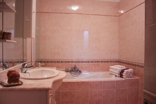 a bathroom with a sink and a tub at Chateau-Gaillard in Corbelin