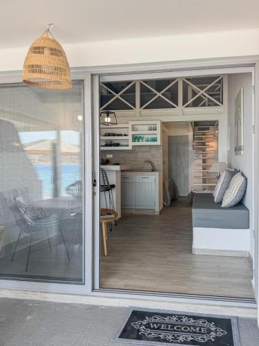 a living room with a sliding glass door to a kitchen at Pallas Seaside 1 in Athens